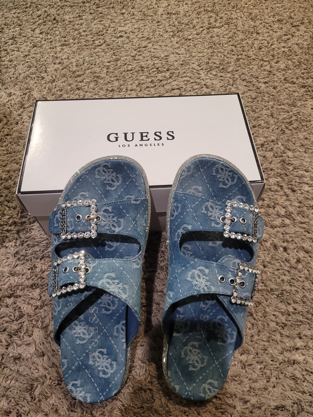 GUESS Denim Logo Slide Sandals in Light Blue with Rhinestone Buckles.
